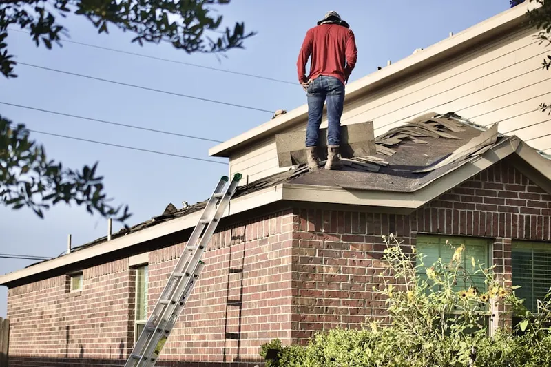 Professional roofer working on a residential roof in Merion Park